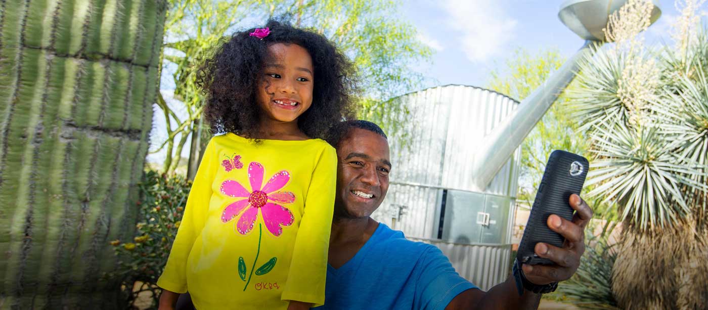 Father and daughter taking selfie in the Gardens