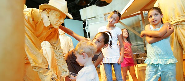 Children exploring the land auction exhibit